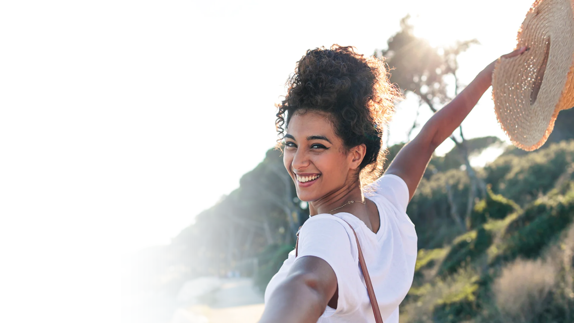 Woman walking down a beach path